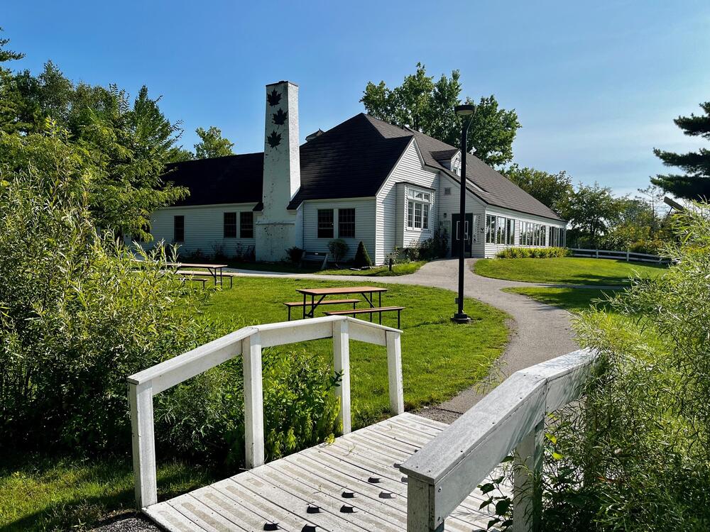 The interpretive center, footbridge and green grounds at Barkhausen Waterfowl Preserve